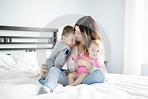 Happy family mother and two children, son and daughter in bed