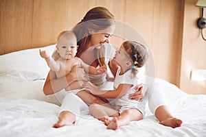 Happy family mother and two children, son and daughter in bed