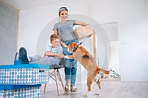 Happy family move in new apartment - mother, son and beagle