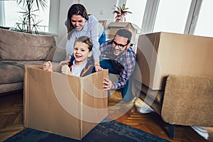 Happy family moving home with boxes around