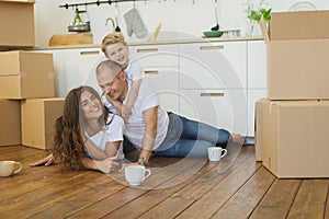 Happy family moving home with boxes around