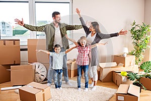 Happy family moving in their new home and having a playtime with their children