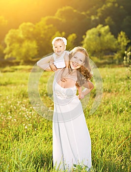 Happy family on nature mother and baby daughter