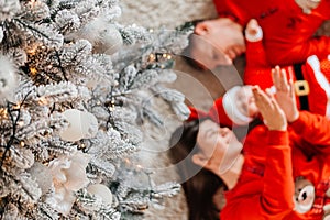 Happy family near the Christmas tree for the New Year