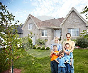 Happy family near new house.