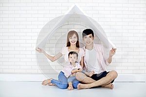 Happy family in new house with roof