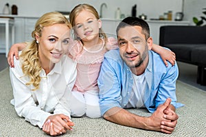 happy family with one child smiling at camera