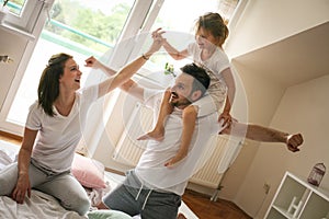 Happy family with one daughter spending time at home.