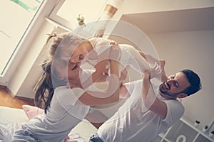 Happy family with one daughter spending time at home.