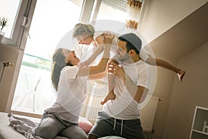 Happy family with one daughter spending time at home.