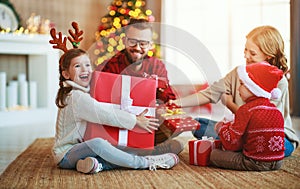 Happy family   open presents on Christmas morning photo