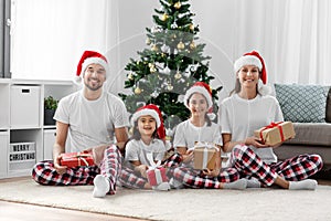 happy family opening christmas gifts at home