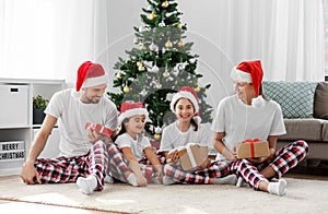 happy family opening christmas gifts at home