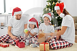 happy family opening christmas gifts at home