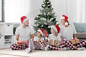 happy family opening christmas gifts at home