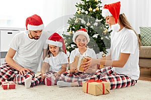 happy family opening christmas gifts at home