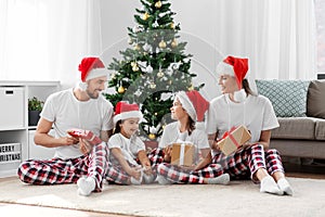 happy family opening christmas gifts at home