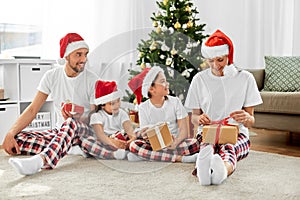 happy family opening christmas gifts at home