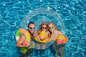 Happy family in outdoor pool