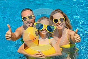 Happy family in outdoor pool