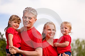 Happy family outdoor in red