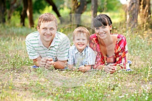 Happy family outdoors on the grass.