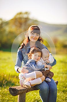 Happy family outdoors on the grass in the Park