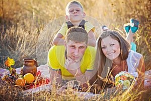 Happy family outdoors in the meadow