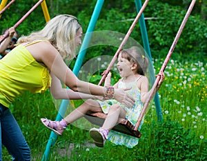 Happy family outdoors mother and kid, child, daughter smiling p