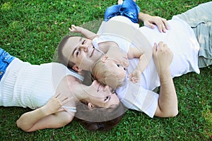 Happy family outdoors mum dad and baby