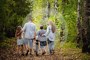 Happy family outdoors smiling in a summer forest