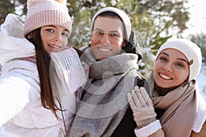 Happy family outdoors on winter day. Christmas vacation