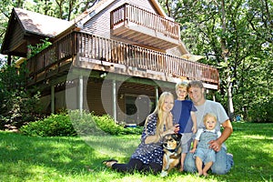 Happy Family Outside by Cabin