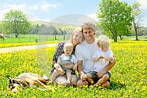 Happy Family Outside in Dandelions