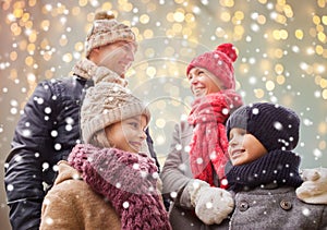 Happy family over christmas lights and snow