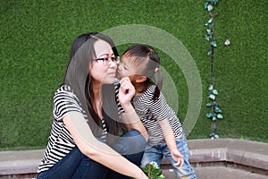 Happy family parental time mother love children daughter kiss mom play with baby girl together have fun in summer park