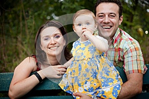 Happy family - parents and baby daughter