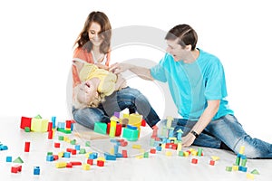 Happy family. Parents playing toys blocks with child