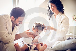 Happy family. Parents with their little girl spending time.