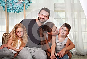 Happy family parents and two children at home