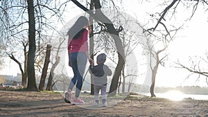 Happy family in the Park. Children's hands together in the sun.