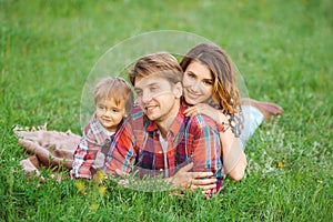 Happy family in a park on grass