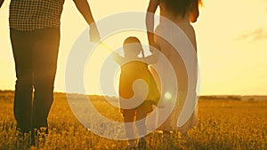 happy family park. little kid daughter runs across meadow sunset. mother father kid child travel together. childhood