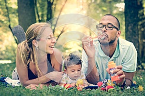 Happy Family in the park in retro filter effect or instagram fi