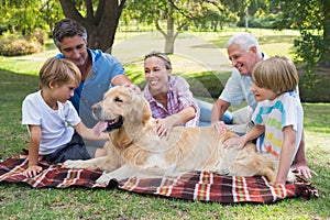 Happy family in the park with their dog