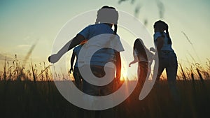 happy family. people in fun park children a kid together run in park at sunset silhouette. mom dad daughter and son run
