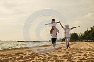 Happy family people having fun in summer vacation on beach