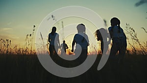 happy family. people in park children a fun kid together run in park at sunset silhouette. mom dad daughter and son run