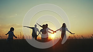 happy family. people in park children a kid together run fun in park at sunset silhouette. mom dad daughter and son run