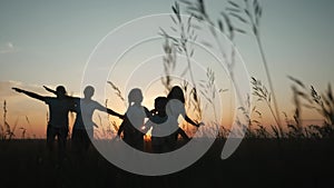 happy family. people in park children a kid together run in fun park at sunset silhouette. mom dad daughter and son run